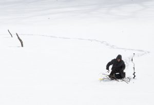 An ice fisherman stakes a spot on the water at Pinhook Park Tuesday, February, 24, 2015, in South Bend. This month is on track to being the snowiest February in more than a century. 