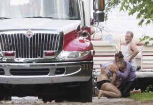 A woman breaks down and cries on the shore next to Baugo Bay as emergency crews respond after a toddler was reported to have fallen off of a boat Saturday June 13, 2015 in Osceola.