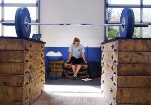 A weightlifter rests during practice at the U.S. Olympic training Center in Colorado Springs.