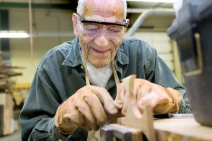 Becky Malewitz/Telegram Carl Bonebrake, 95, works on a project during woodworking class which he takes with his daughter. He is currently making handmade crosses for each of his grandchildren.